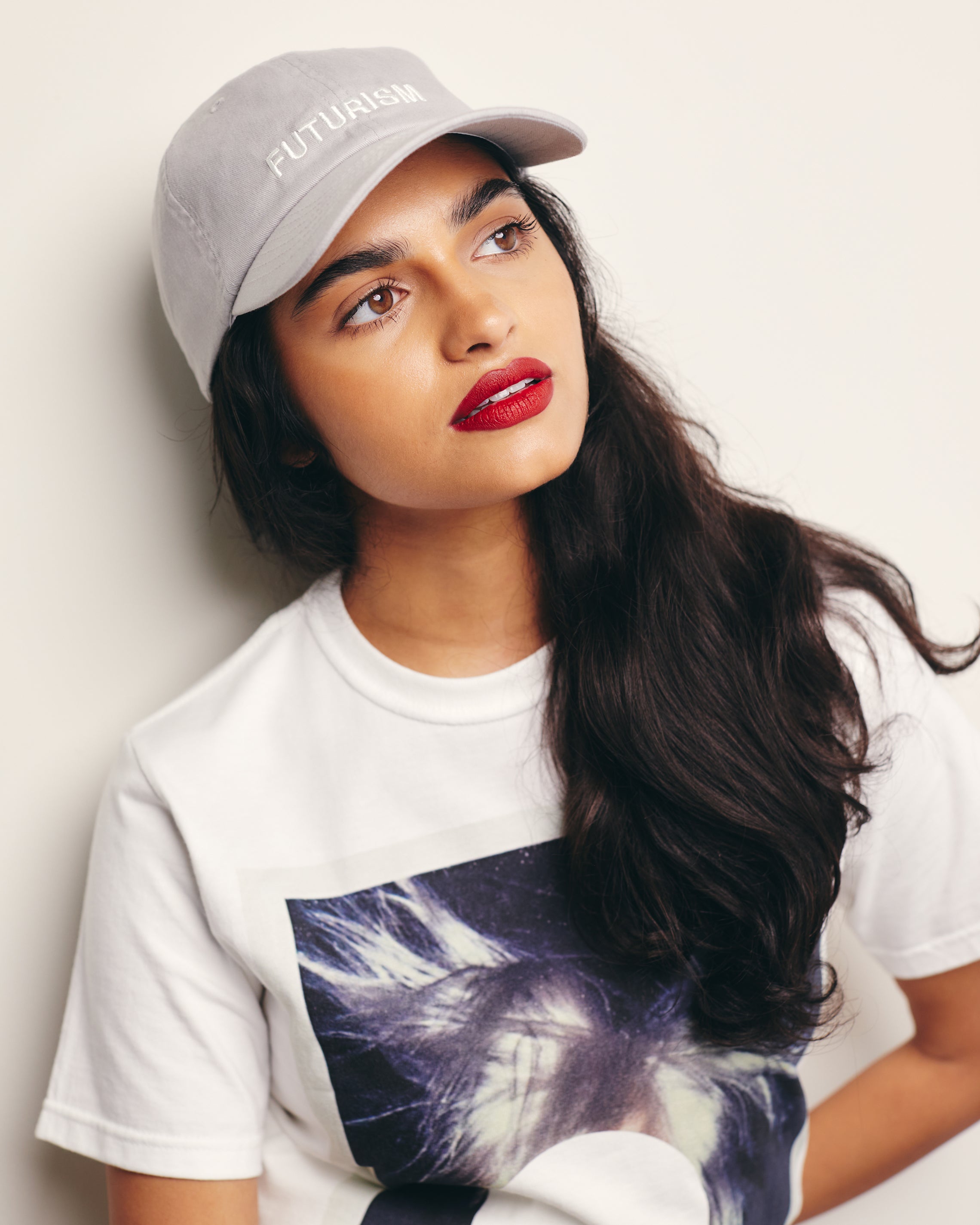 Mira Bhat wears Futurism Gray Baseball Cap / Dad Hat with Futurism Art Movement Text Embroidery on Front. 100% Cotton.