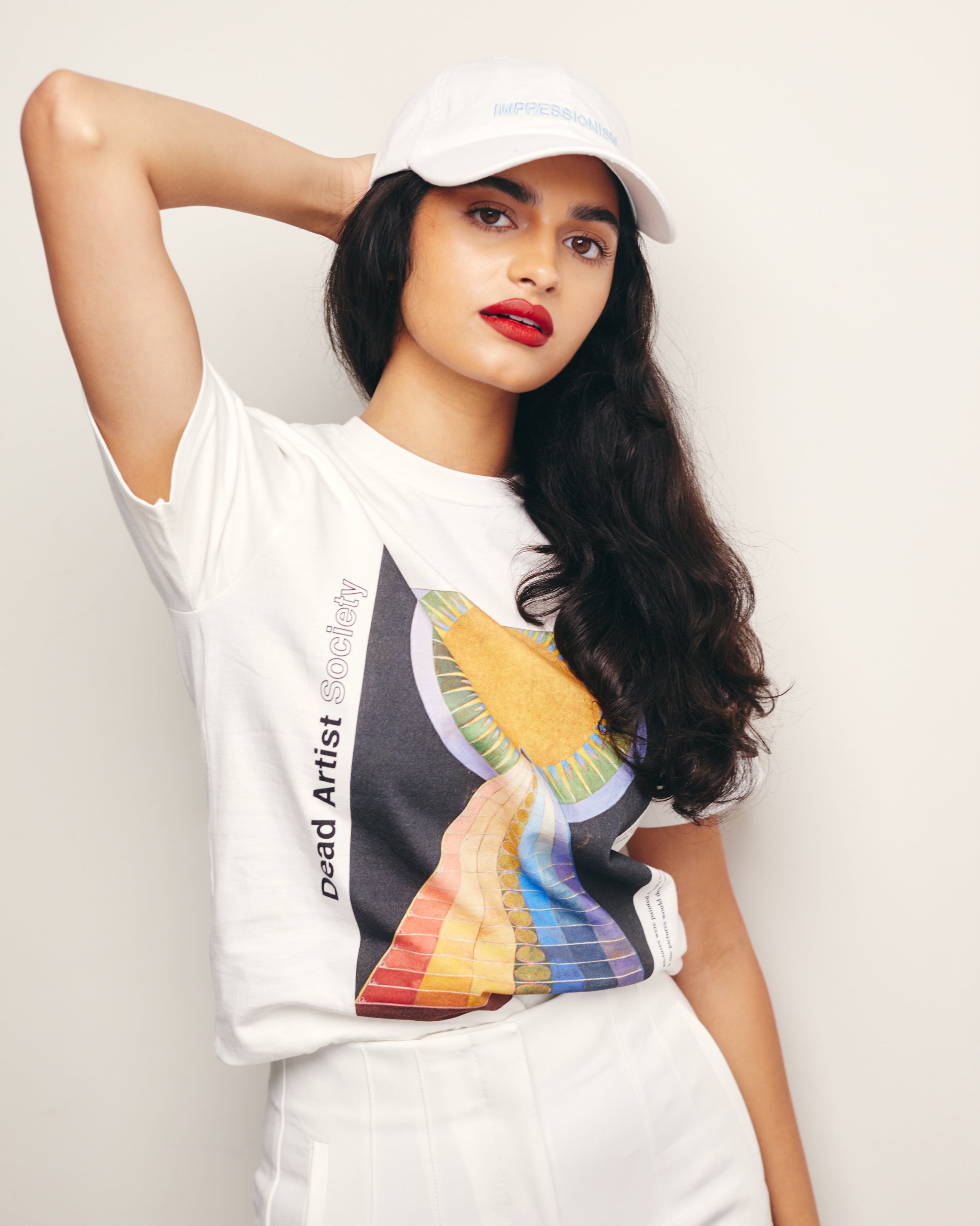 Mira Bhat wears White Organic Short Sleeve 100% Cotton Tee with graphic print of Hilma af Klint’s Altarpiece No. 1.