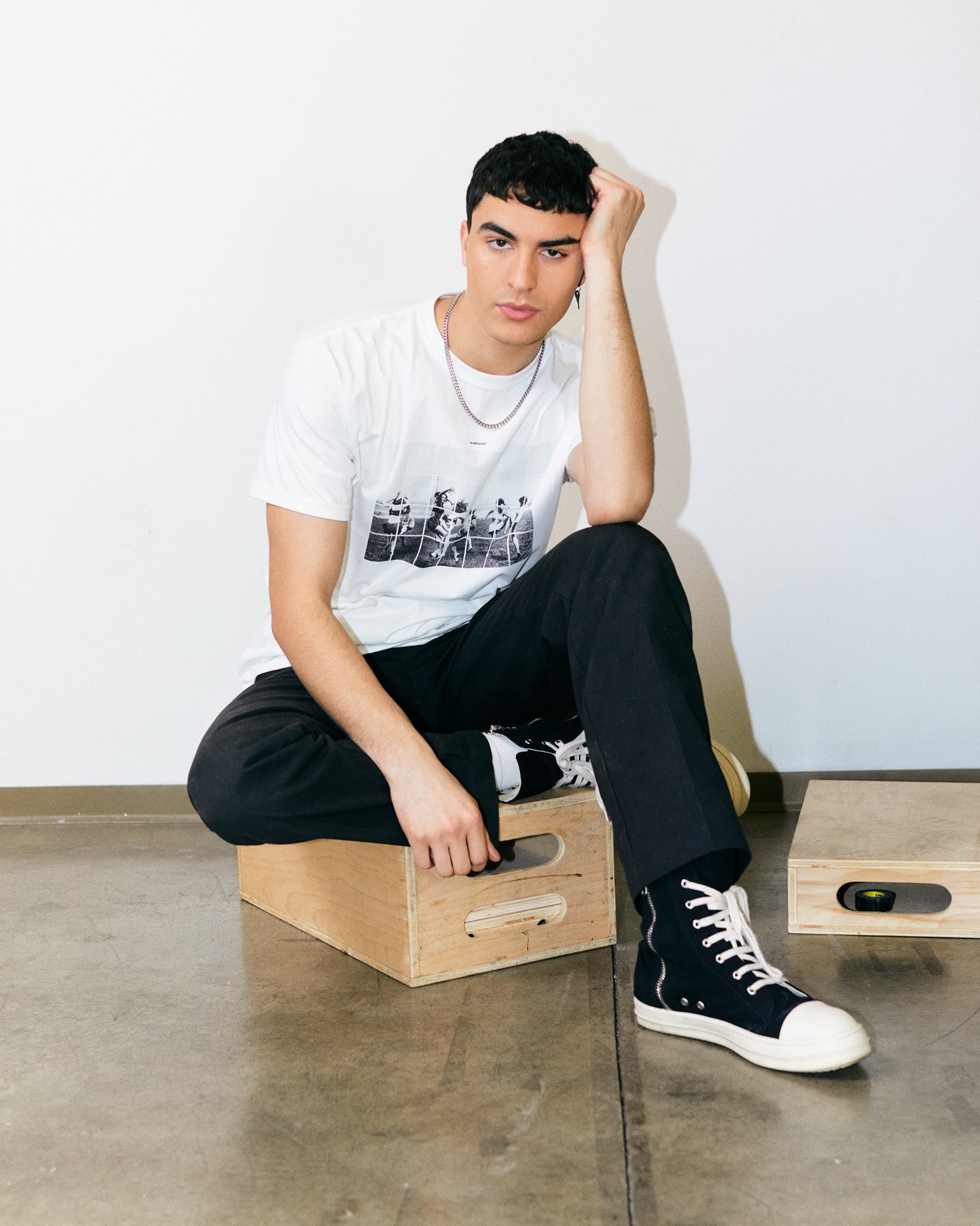 arjang Mahdavi wears White/ Chalk Organic Short Sleeve 100% Cotton Tee with graphic print of Dancing Girls of the Bauhaus from the Bauhaus Collection.