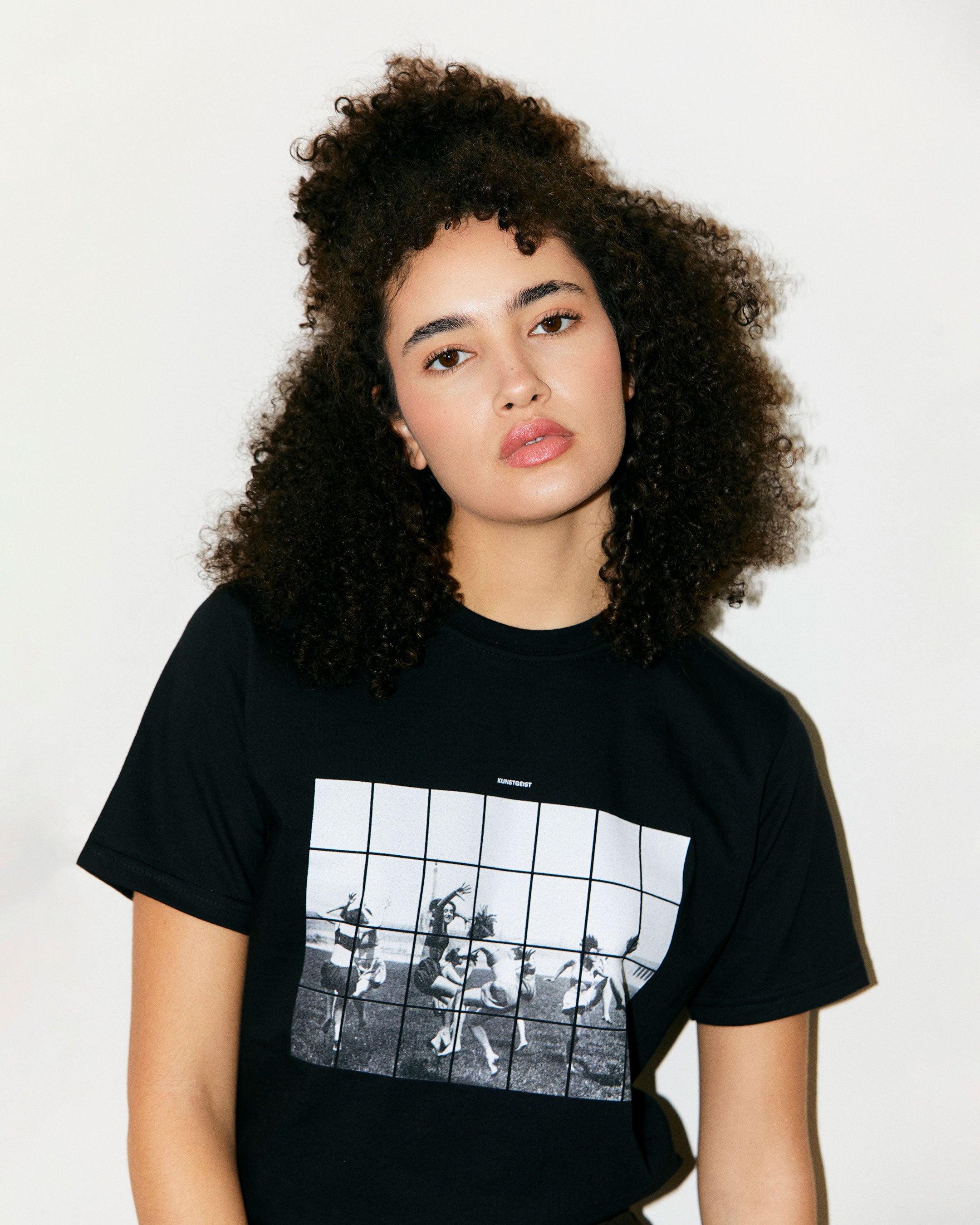 Teodora Marcella wears Black Organic Short Sleeve 100% Cotton Tee with graphic print of Dancing Girls of the Bauhaus from the Bauhaus Collection.