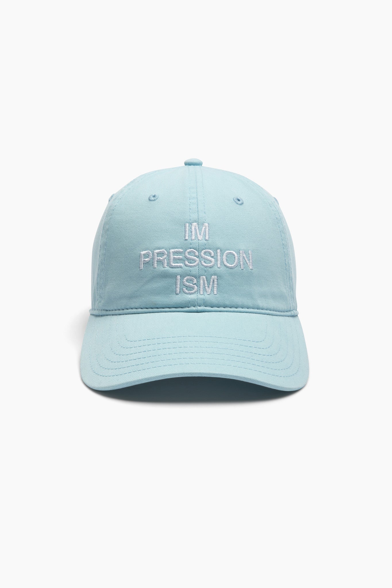 Light blue cap with 'IM PRESSION ISM' text on a white background