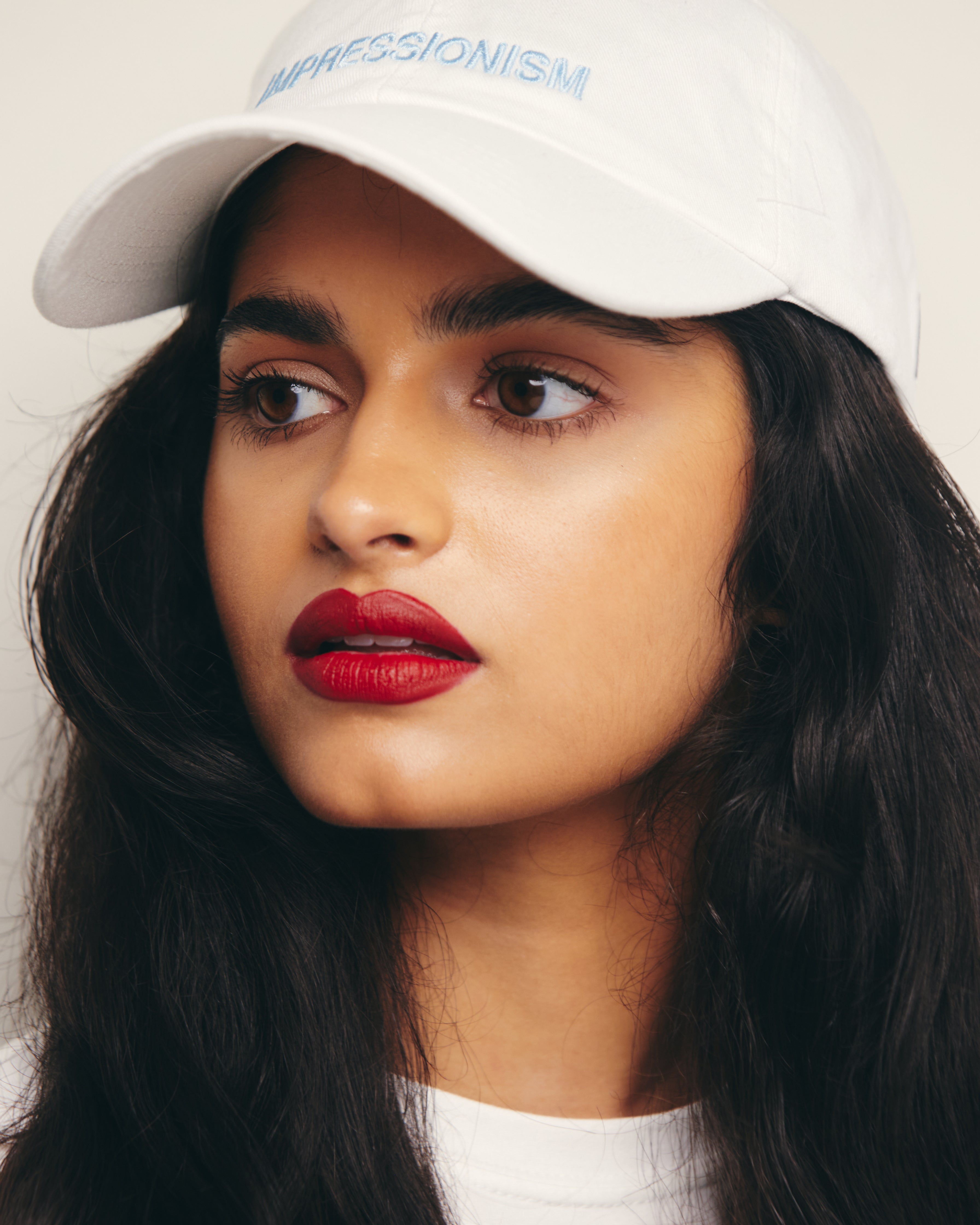 Mira Bhat wears White  Baseball Cap / Dad Hat with Impressionism Art Movement Text Embroidery on Front. 100% Cotton.