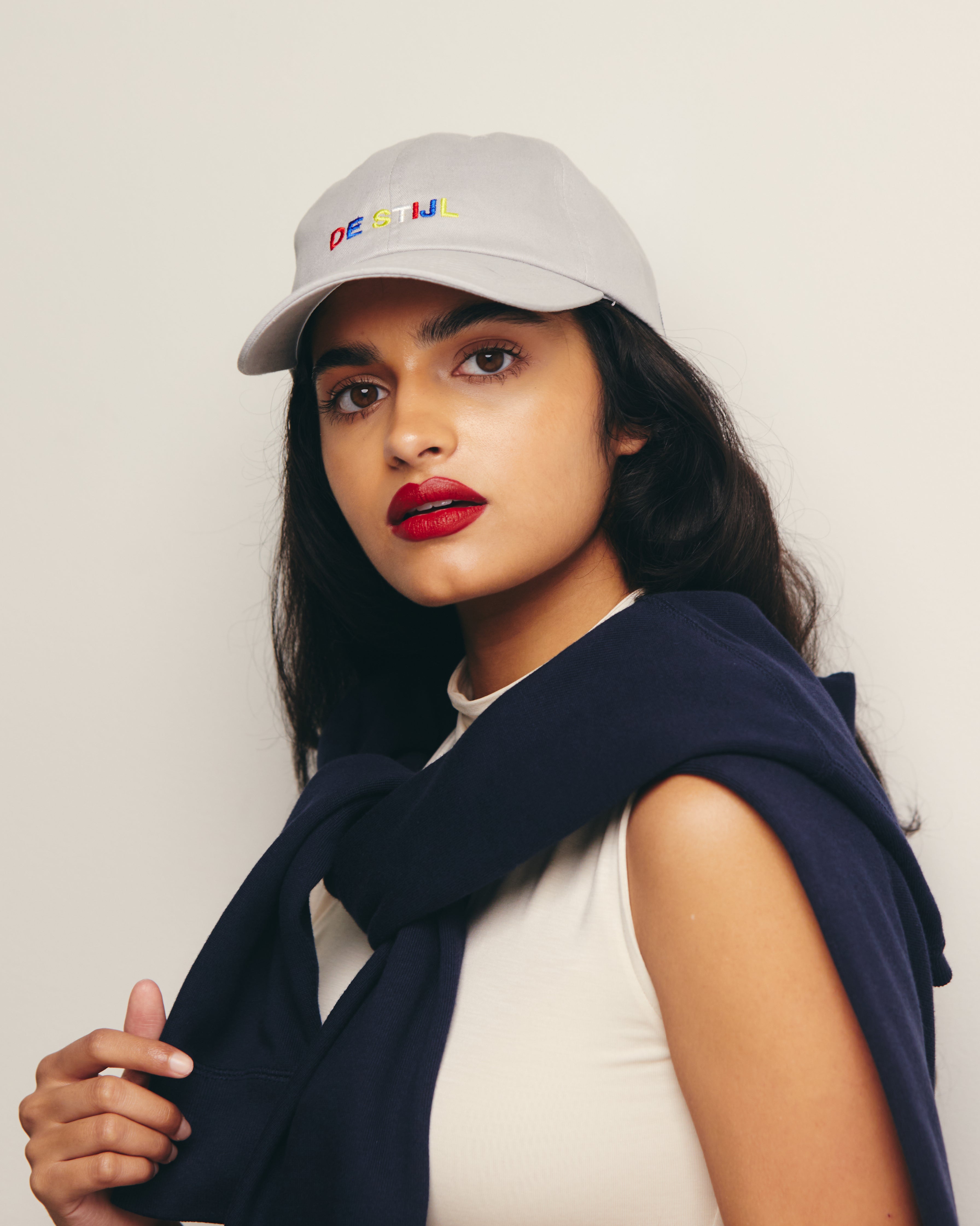 Mira Bhat wears Gray Baseball Cap / Dad Hat with De Stijl Art Movement Text Embroidery on Front. 100% Cotton.