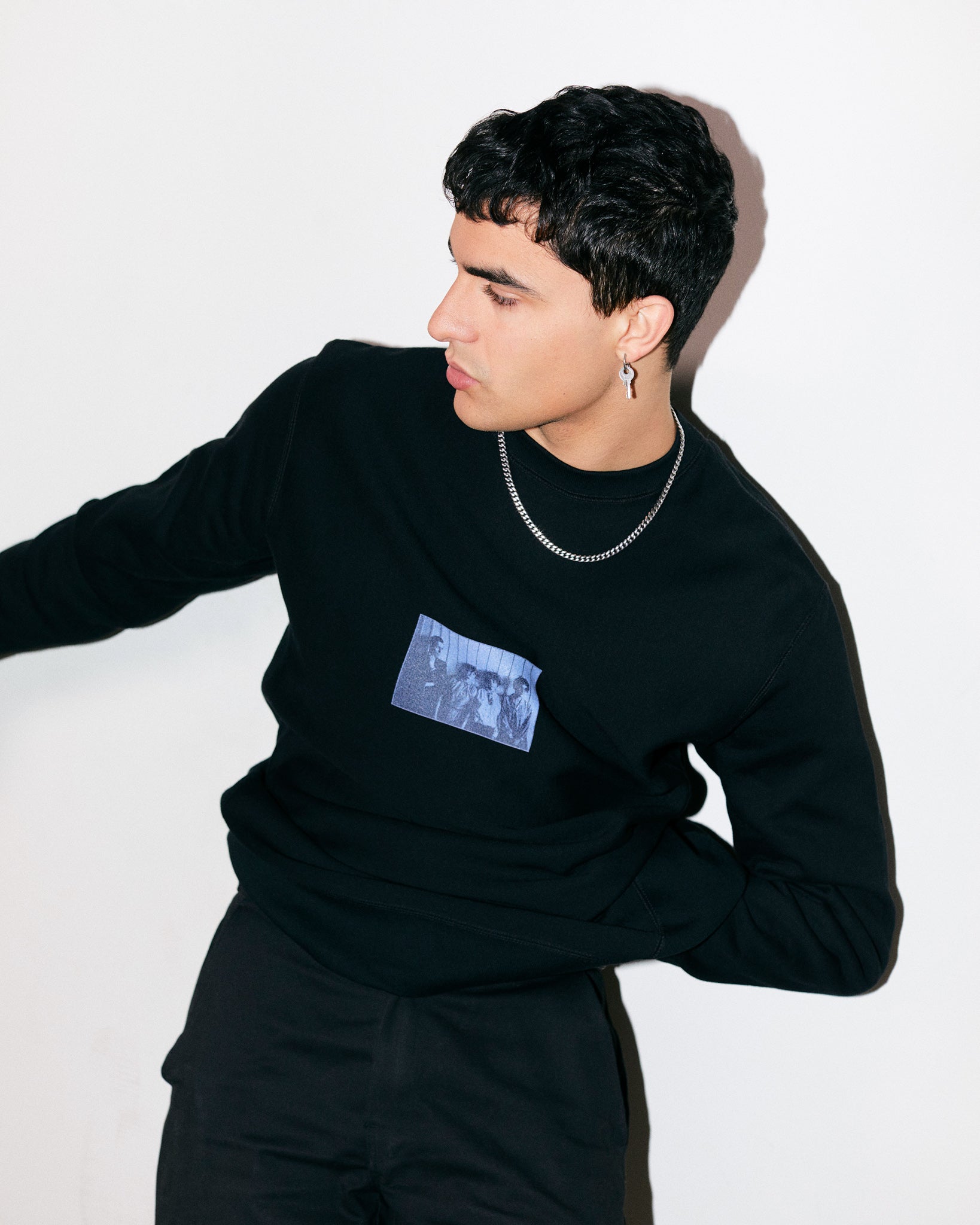 Arjang Mahdavi Wears Heavyweight Black Crewneck Sweatshirt Tee With Print Of Photograph Of Bauhaus Students Marcel Breuer, Marta Erps-Breuer, Katt Both And Ruth Hollos-Consemüller In 1927 Modernism Art Movement