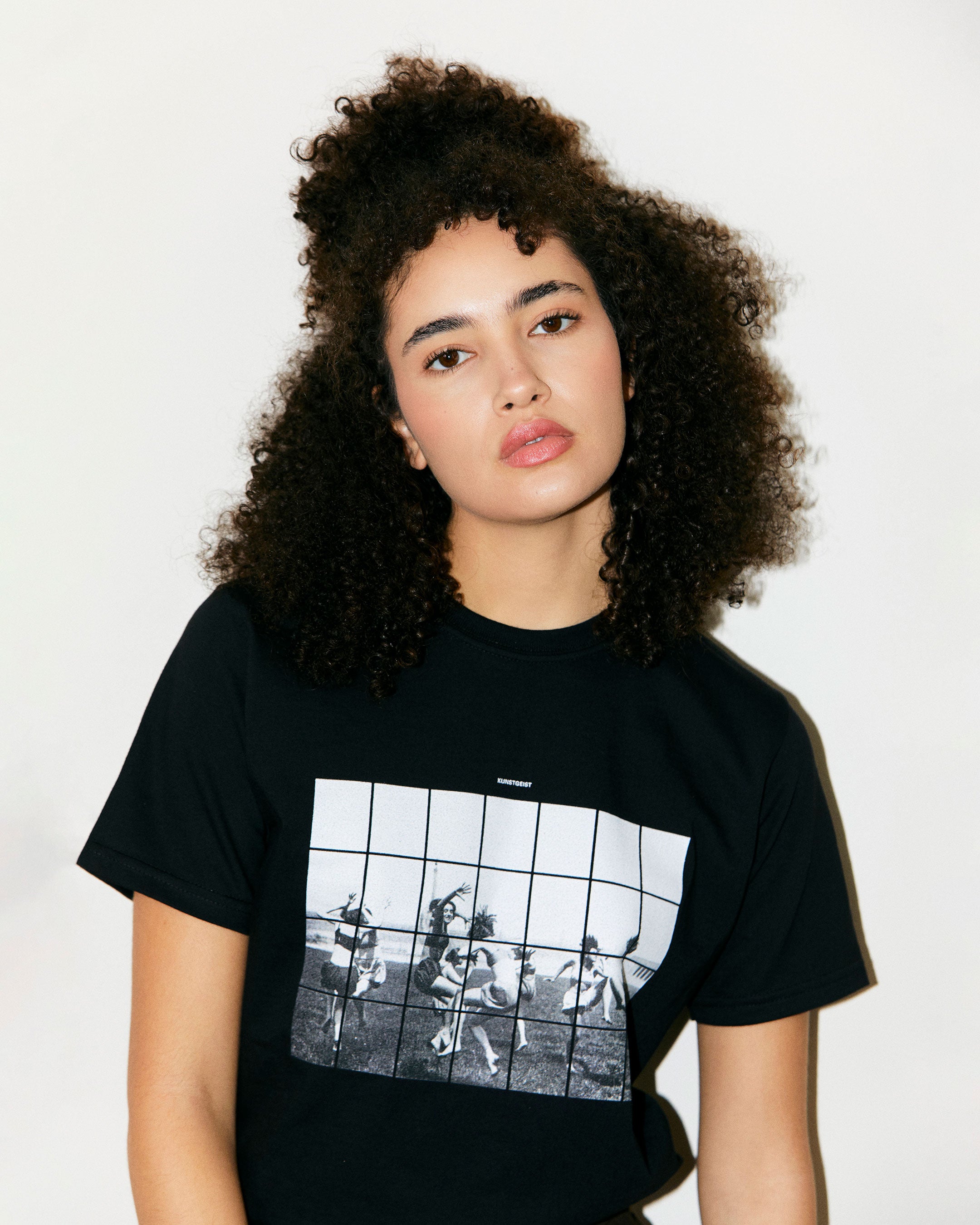 Teodora Marcella wears Black Organic Short Sleeve 100% Cotton Tee with graphic print of Dancing Girls of the Bauhaus from the Bauhaus Collection. 